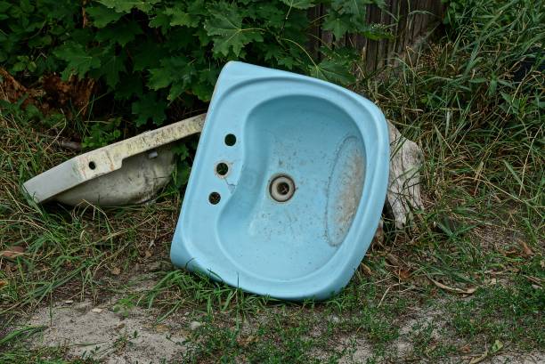 istock old blue ceramic sink on the ground in green grass 1003090546