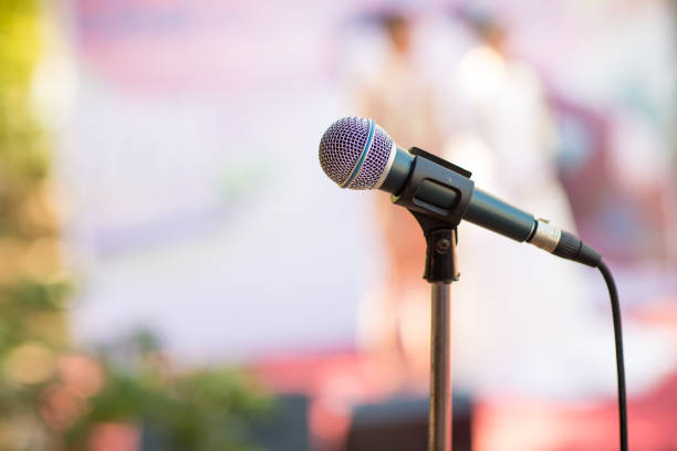 istock microphone in concert hall or conference room soft and blur style for background. 1003093662