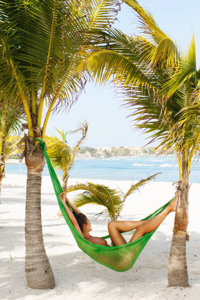 istock Happy and beautiful woman lying in the hammock 1003108204