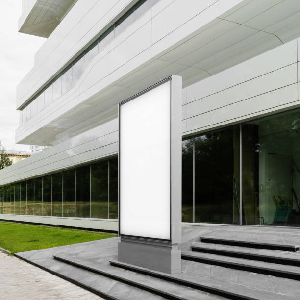 istock Blank white banner next to white modern building, side view. 3d rendering 1003110724