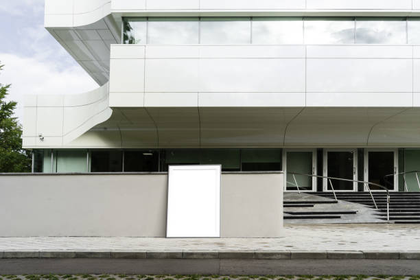 istock Blank white poster next to white modern business center. 3d rendering 1003110764