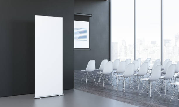 istock Blank white roll up next to meeting room in modern office, 3d rendering 1003111244