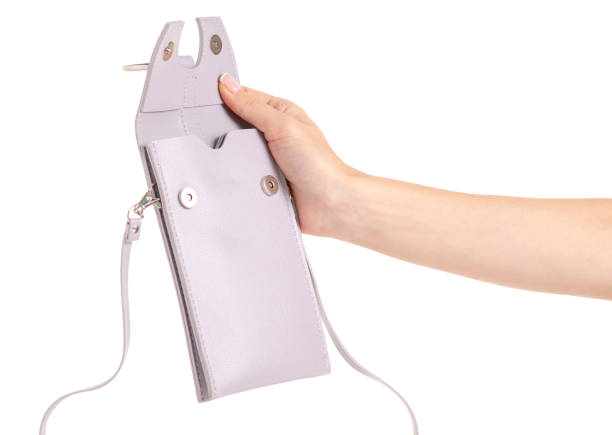 istock Small gray female bag case for mobile phone smartphone in hand 1003111802