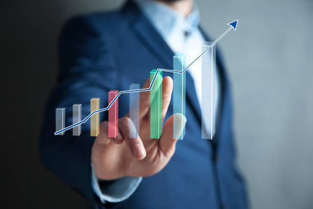 istock businessman holding a hand-drawn bar graph in his hand 1003112120