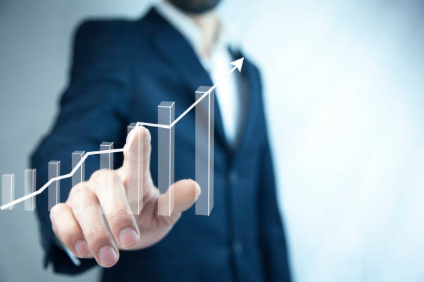 istock businessman holding a hand-drawn bar graph in his hand 1003112294