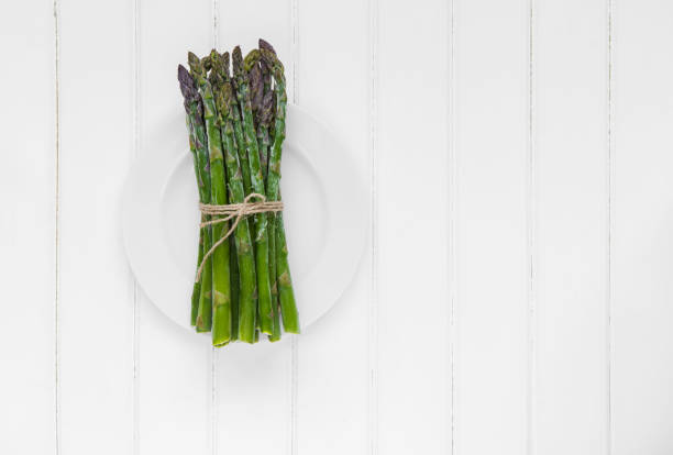 Bunch of fresh asparagus on wooden table