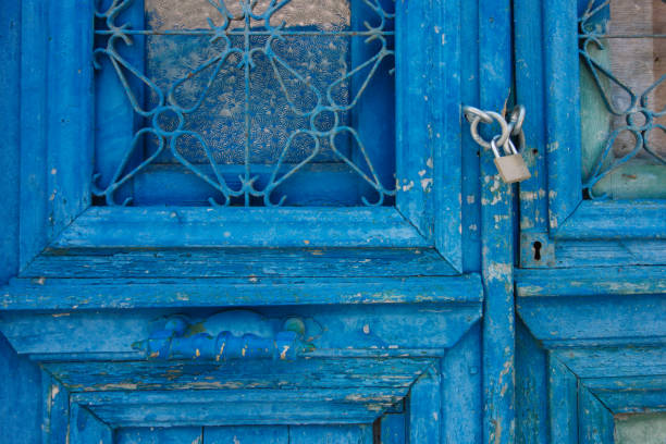 Old weathered wooden door with padlock