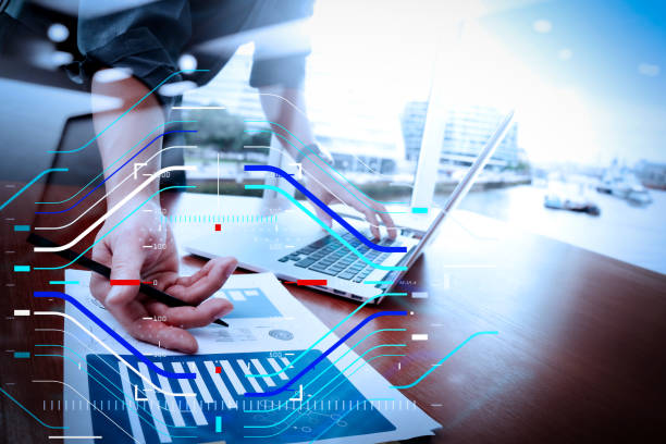 istock business documents on office table with smart phone and laptop computer and graph business with social network diagram and man working in the background 1003115648