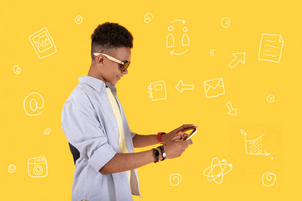 istock Positive teenager typing messages and smiling 1003115814