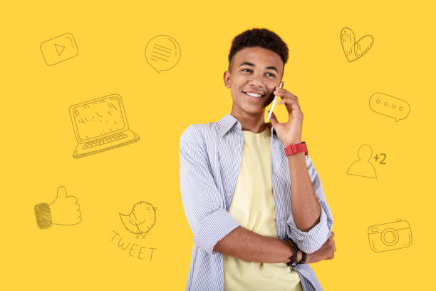 istock Handsome popular blogger talking on the phone and smiling cheerfully 1003122520