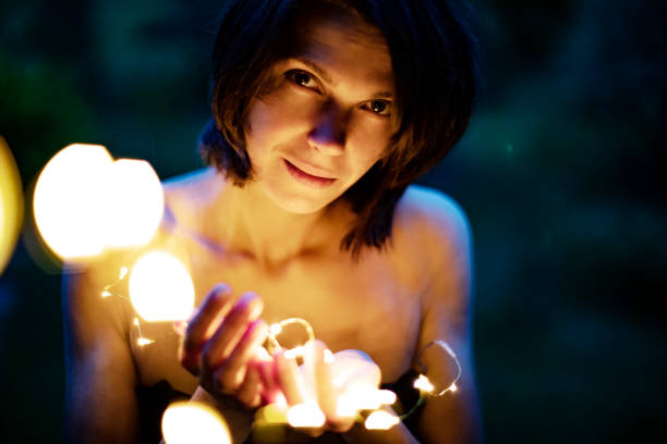 istock Christmas lights in woman hands 1003126348