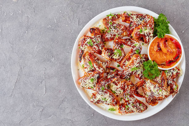 istock chicken wings sprinkled with grated parmesan 1003130378