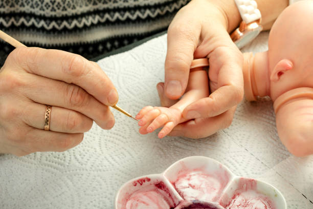 istock Hand painted dolls. Painting brush fingers. 1003133112
