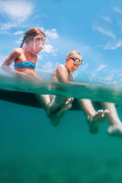 istock Two happy smiling childs sit on inflatable raft 1003136668