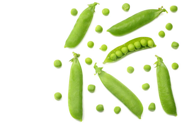 istock fresh green peas isolated on a white background. top view 1003139740