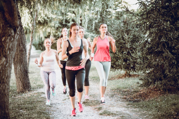 istock Group Of Female Athletes Jogging In Nature 1003141592