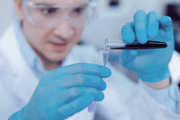 istock Selective focus of a test tube with dark blue liquid 1003147108