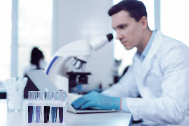istock Selective focus of test tubes with blue liquids 1003147196