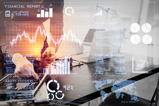 istock businessman or Designer using smart phone with latop and digital tablet computer and document on desk in modern office with London city background,double exposure 1003150884