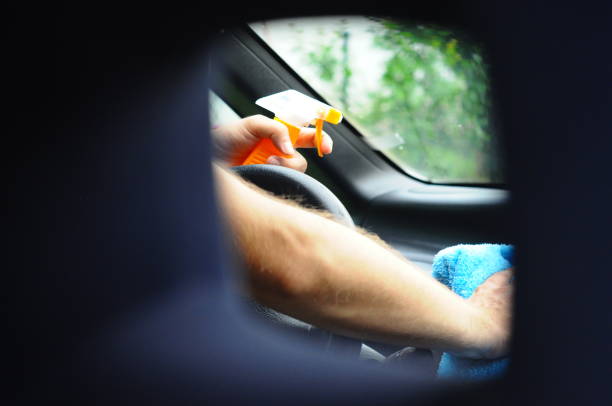 istock Cleaning the car inside - Men hands clean the car 1003153616