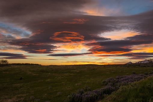The sunset is reflected in the clouds near island of Hrisey in Iceland