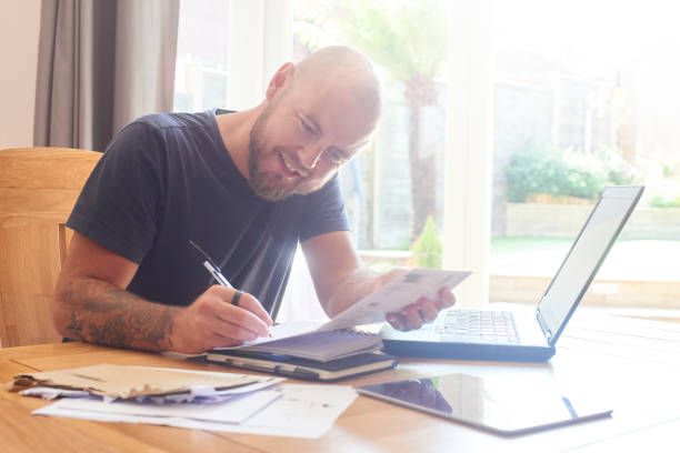 istock Happy male signing paperwork at work 1003163514
