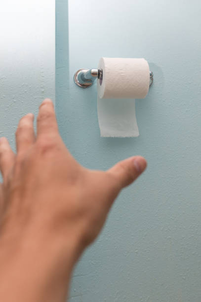 istock toilet paper on wall 1003166030