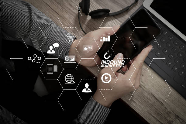 istock top view of man hand using VOIP headset with digital tablet computer docking keyboard,smart phone,concept communication, it support, call center and customer service help desk on wooden table 1003172384