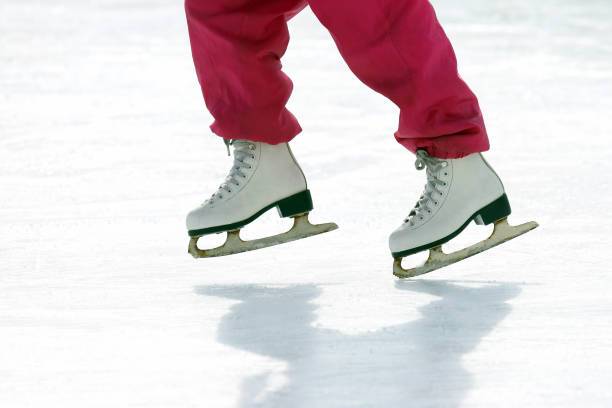 istock girl skates on ice rink 1003181468