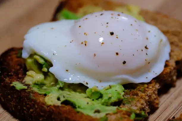 Smashed avocado on brown toast with a poached egg - perfect Aussie breakfast