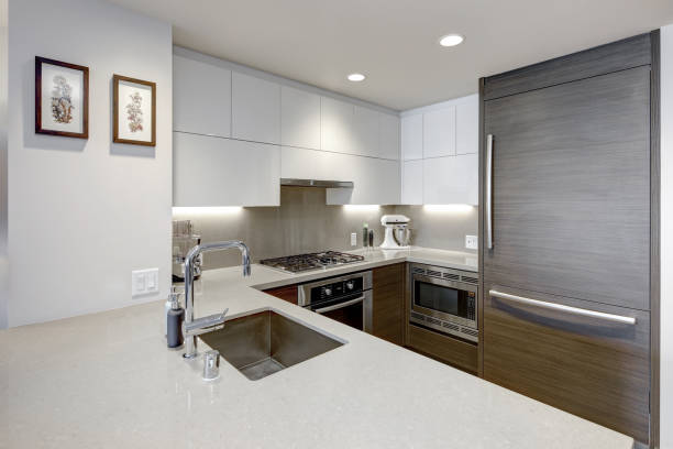 istock Modern style kitchen with wood paneled refrigerator. 1003193250