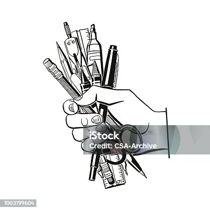 istock Hand Holding Writing Utensils 1003199604