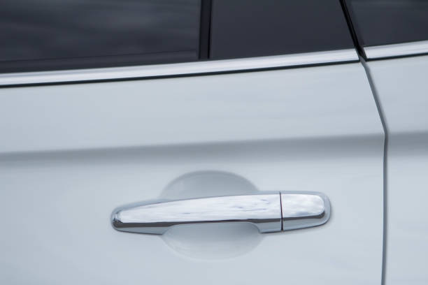 istock Closeup of white car door handle front view. 1003203932