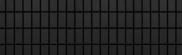 istock Panorama of Black brick wall pattern and seamless background 1003209602