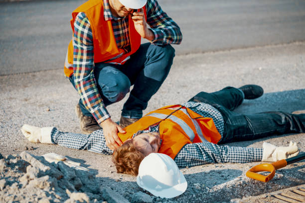 Worried man calling ambulance for his unconscious coworker Worried man calling ambulance for his uncosncious coworker fainted stock pictures, royalty-free photos & images
