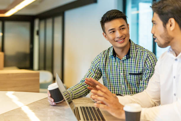 istock Casual Businessmen Having a Meeting Together With a Laptop Computer 1003215688