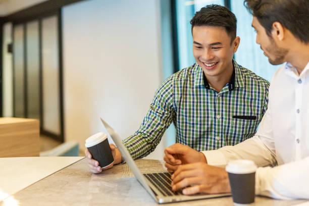 istock Casual Businessmen Having a Meeting Together With a Laptop Computer 1003215692