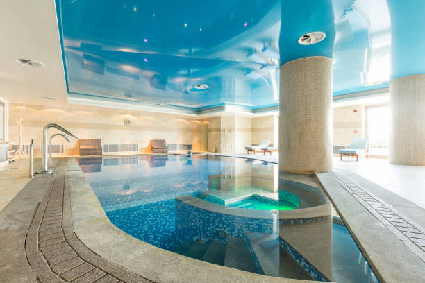 istock Indoor swimming pool in hotel spa center 1003221236