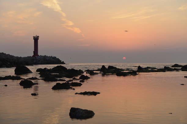 istock Light house on the ocean and sunset landscape 1003222006