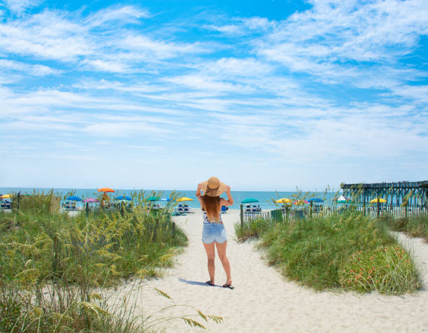 istock Girl waking on the beach. 1003225640