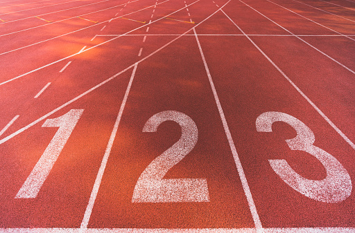 Starting line position of running track background texture, lane number 1, 2, 3. Business competition conceptual, or athletic racing sport concept