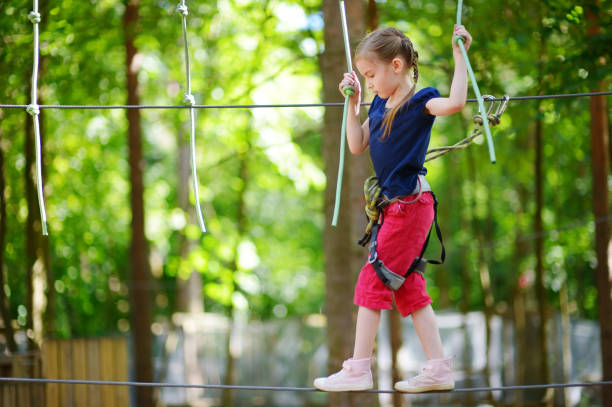 istock Little girl enjoying her time in adventure park 1003238708