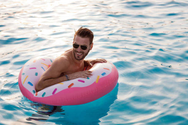 istock Man enjoying the swimming pool 1003246140