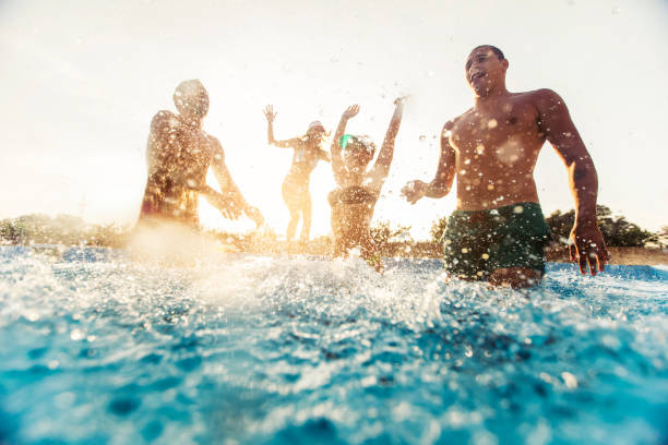 istock Friends having fun at the swimming pool 1003246142
