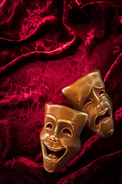 istock Theater masks over red curtain / 3D rendering 1003251620