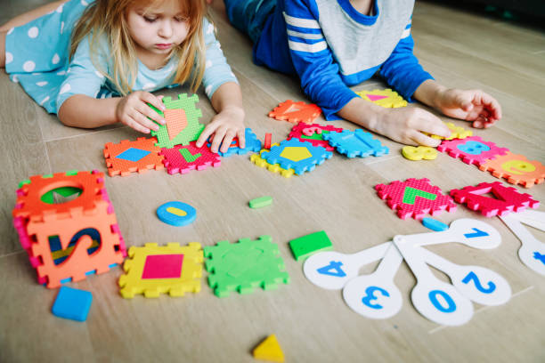 istock kids learning numbers, calculations, play with puzzle 1003251636