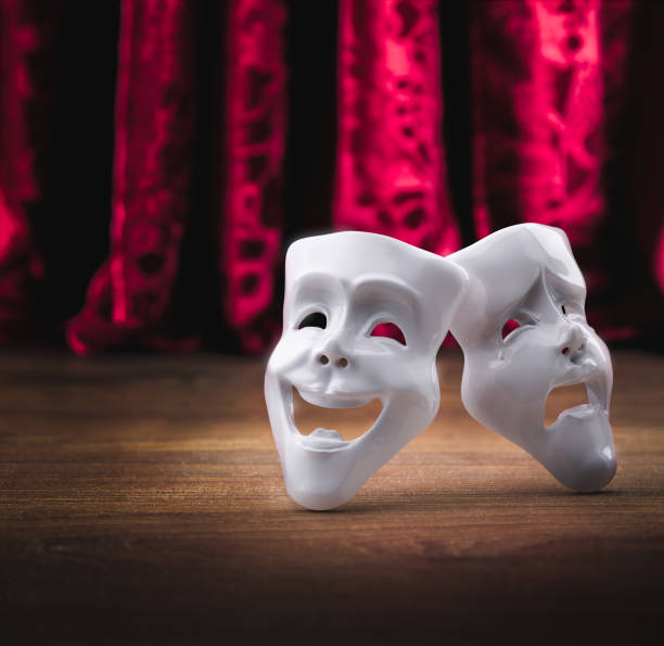 istock Theater masks in front of a red curtain/ 3D rendering 1003257432