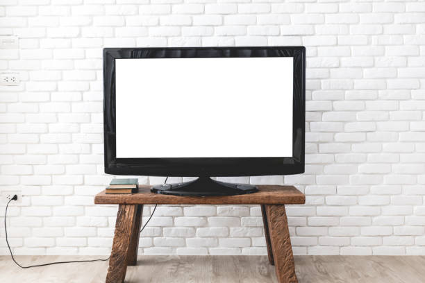 Empty white flat TV screen hanging on a white wall. stock photo