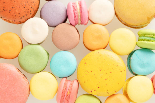 istock Pattern of colourful french macarons on white background. 1003257534