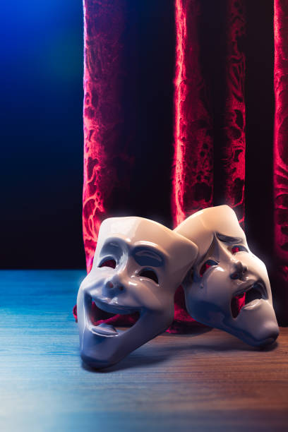 istock Theater masks in front of a red curtain/ 3D rendering 1003262526